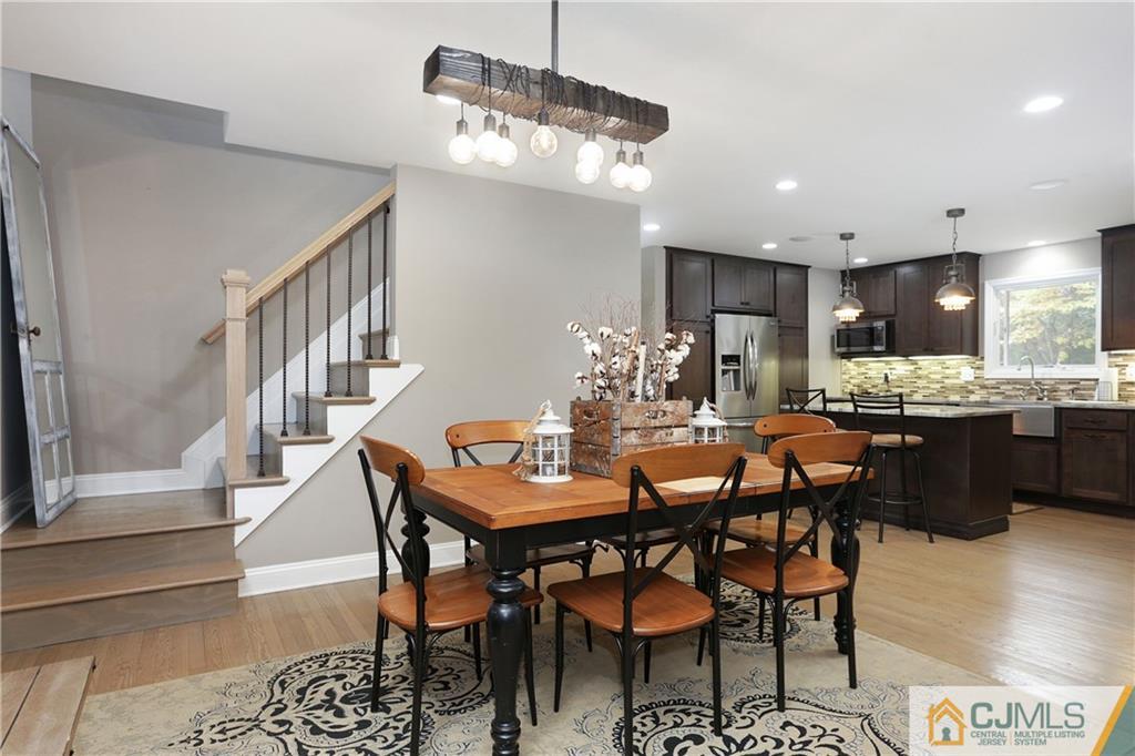 556 Ridge Road Monmouth Junction, NJ 08852 - Photo 4 of 19 a dining room with furniture a chandelier and wooden floor