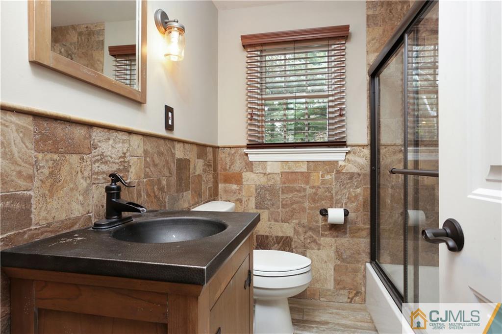 556 Ridge Road Monmouth Junction, NJ 08852 - Photo 8 of 19 a bathroom with a sink a toilet and shower
