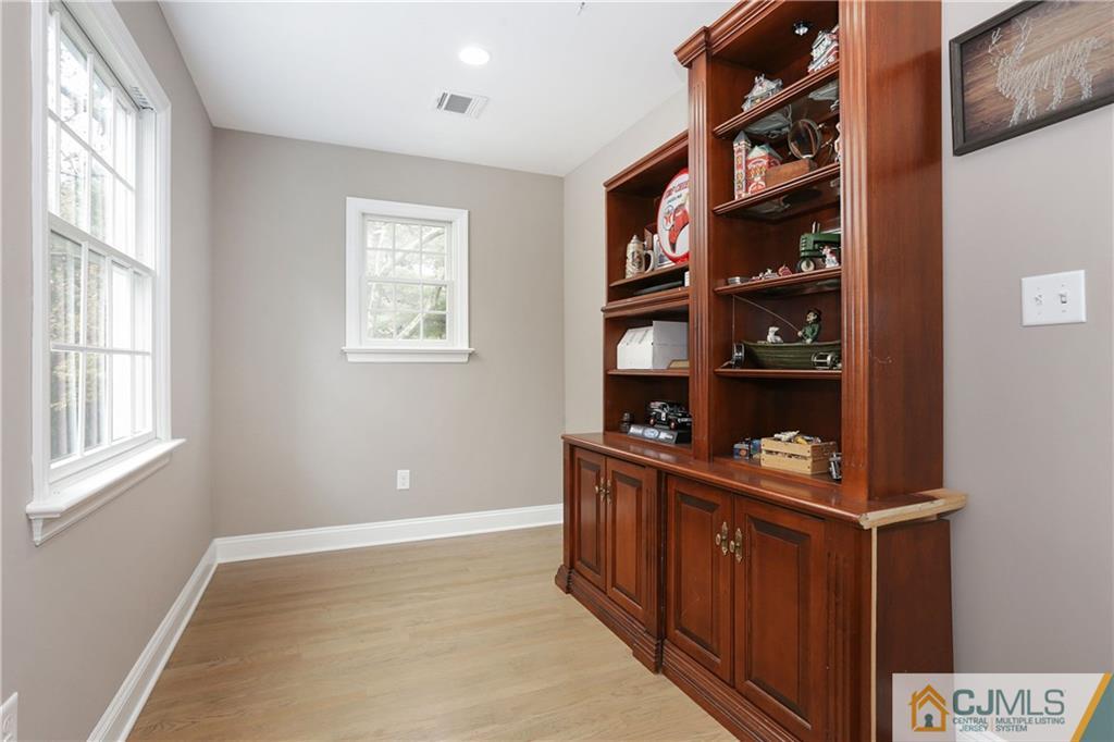 556 Ridge Road Monmouth Junction, NJ 08852 - Photo 10 of 19 a room with furniture a bookshelf and a window