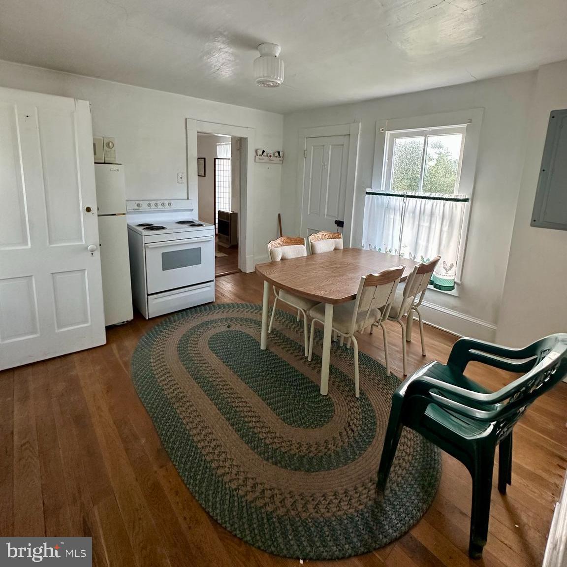 14065 South Middle Road Edinburg, VA 22824 - Photo 5 of 5 a living room with furniture a dining table and a rug