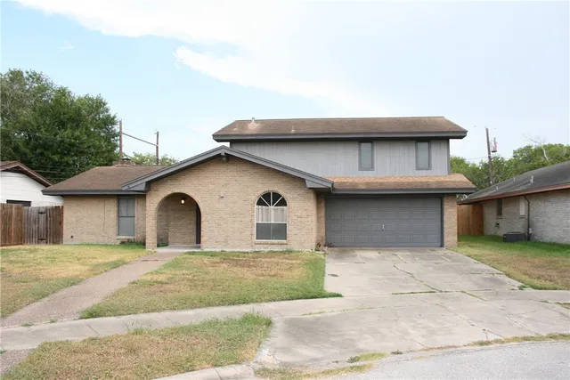 a house that has a tree in front of it