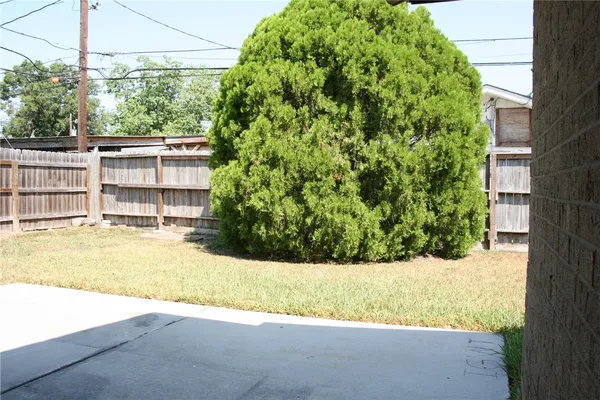 a view of a house with a yard and potted plants