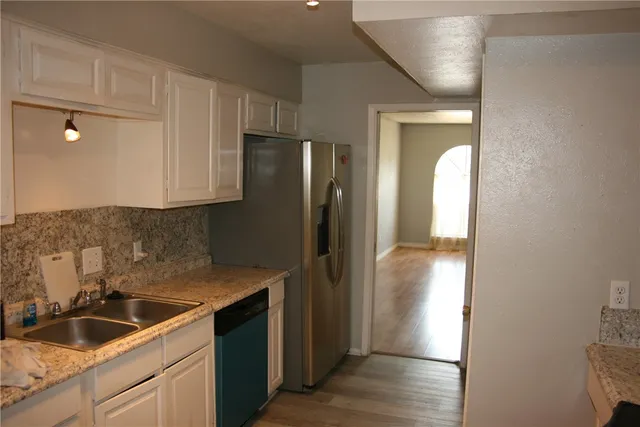 a kitchen with a refrigerator and a sink