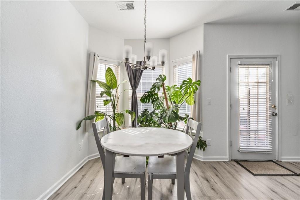 2744 Snapfinger Manor Decatur, GA 30035 - Photo 11 of 29 a view of a dining room with furniture and a potted plant