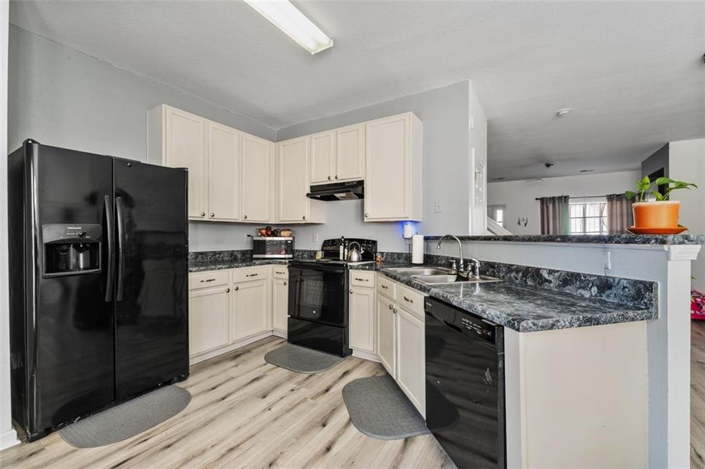 2744 Snapfinger Manor Decatur, GA 30035 - Photo 13 of 29 a kitchen with a refrigerator stove and sink