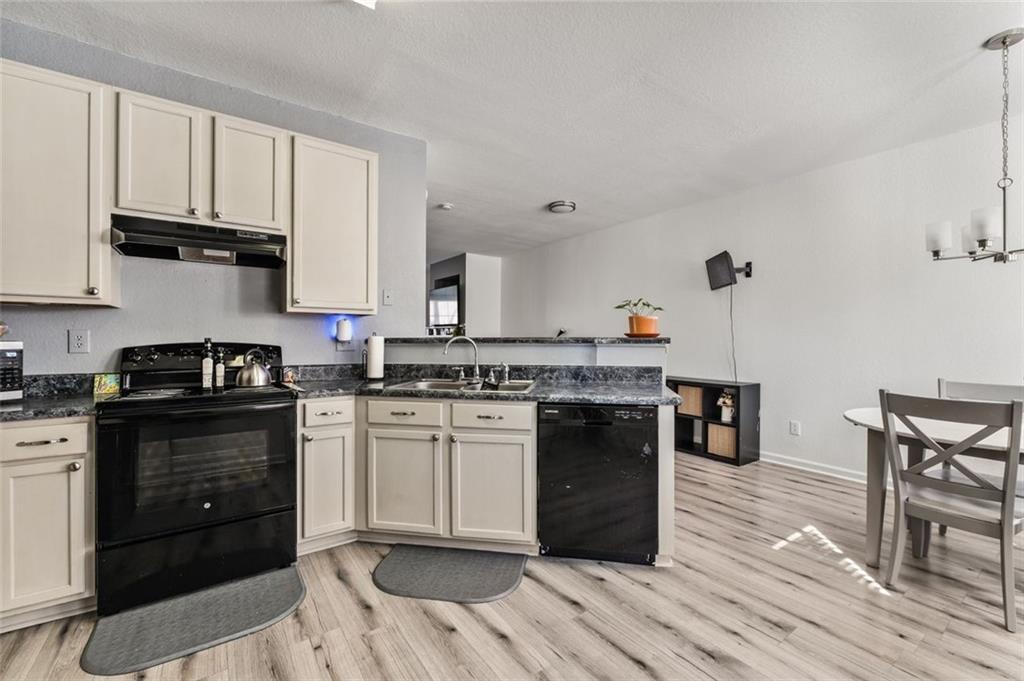 2744 Snapfinger Manor Decatur, GA 30035 - Photo 14 of 29 a kitchen with a stove a sink and a refrigerator