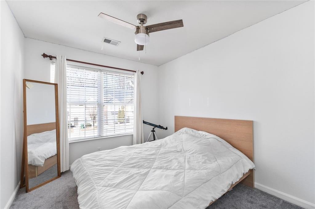 2744 Snapfinger Manor Decatur, GA 30035 - Photo 21 of 29 a bedroom with a large bed and a large window