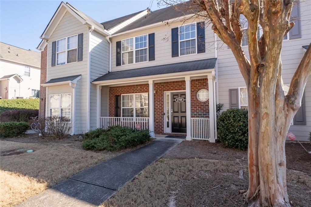 2744 Snapfinger Manor Decatur, GA 30035 - Photo 4 of 29 a view of a brick house with large windows and large trees