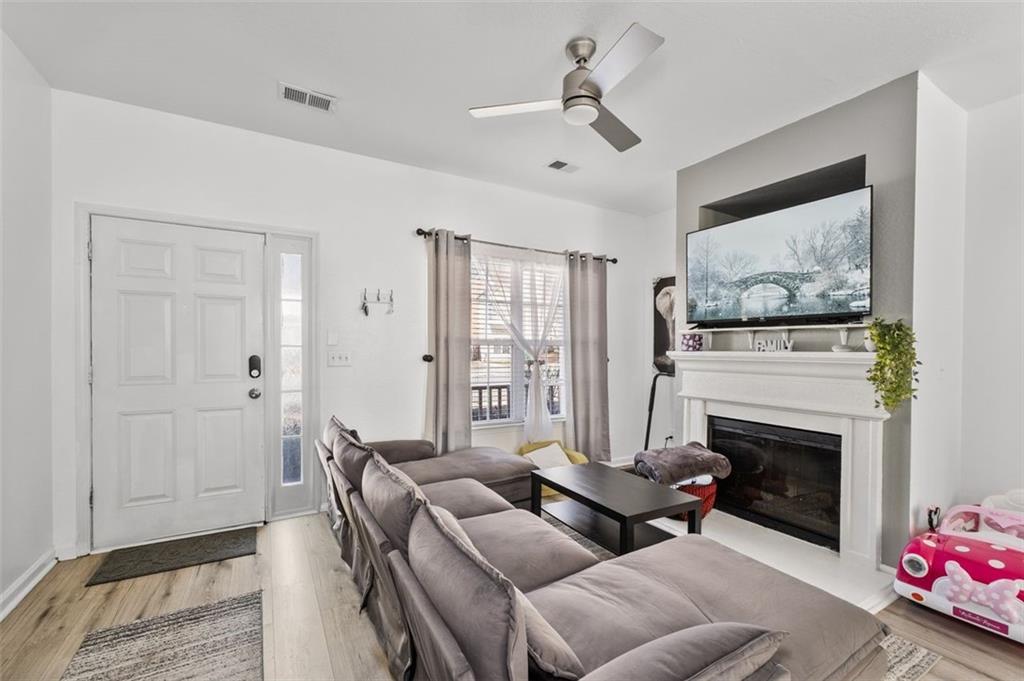 2744 Snapfinger Manor Decatur, GA 30035 - Photo 7 of 29 a living room with furniture a flat screen tv and a fireplace