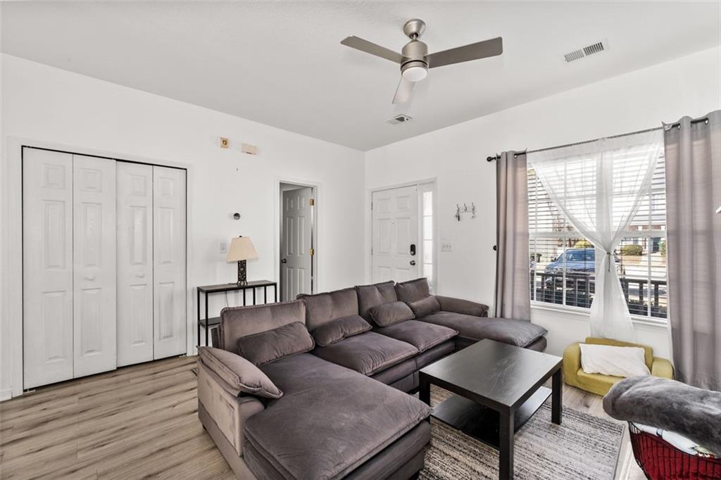 2744 Snapfinger Manor Decatur, GA 30035 - Photo 8 of 29 a living room with furniture and a large window