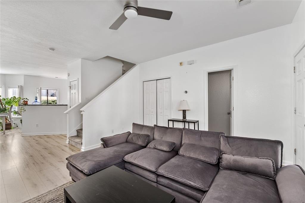 2744 Snapfinger Manor Decatur, GA 30035 - Photo 9 of 29 a living room with furniture and a wooden floor