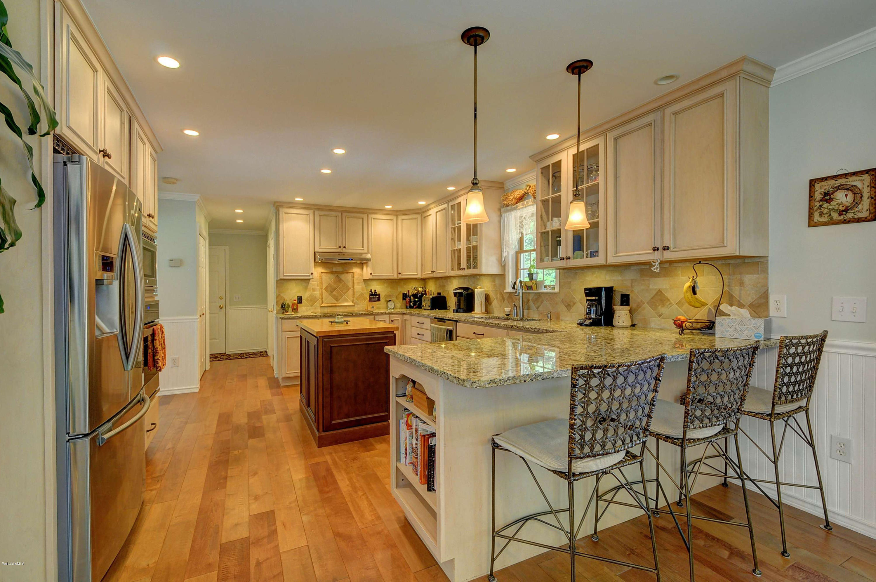 265 Smith Road Hinsdale, MA 01235 - Photo 15 of 27 a kitchen with stainless steel appliances granite countertop a sink a stove a refrigerator and island with wooden floor