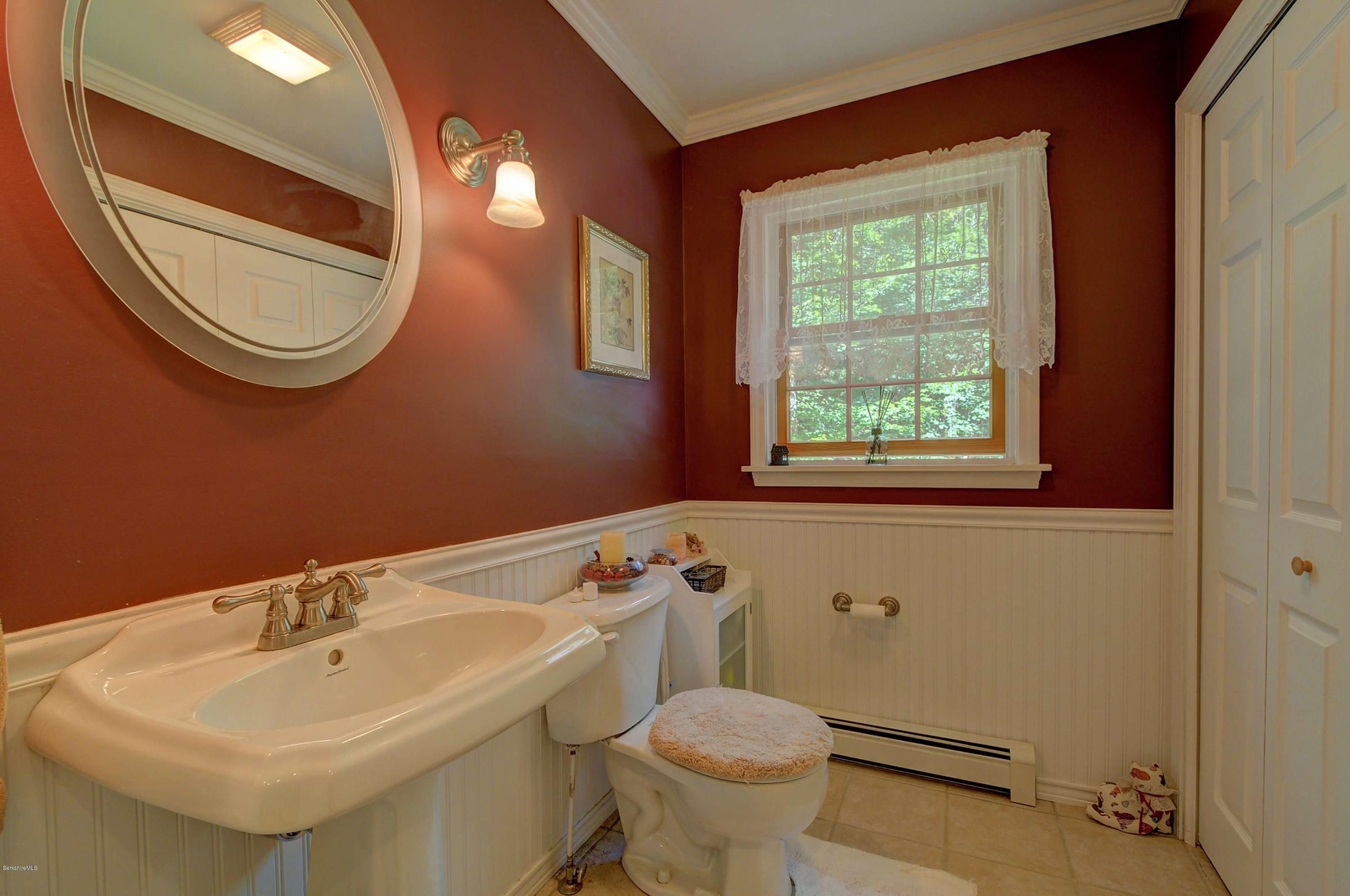 265 Smith Road Hinsdale, MA 01235 - Photo 21 of 27 a bathroom with a sink a mirror a toilet and a window