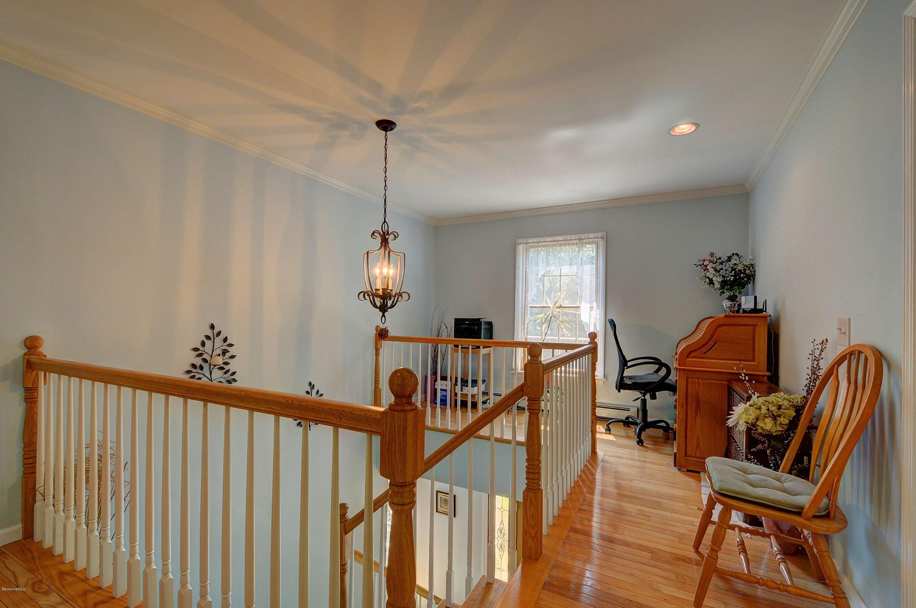 265 Smith Road Hinsdale, MA 01235 - Photo 22 of 27 a view of a livingroom with furniture wooden floor windows and a chandelier