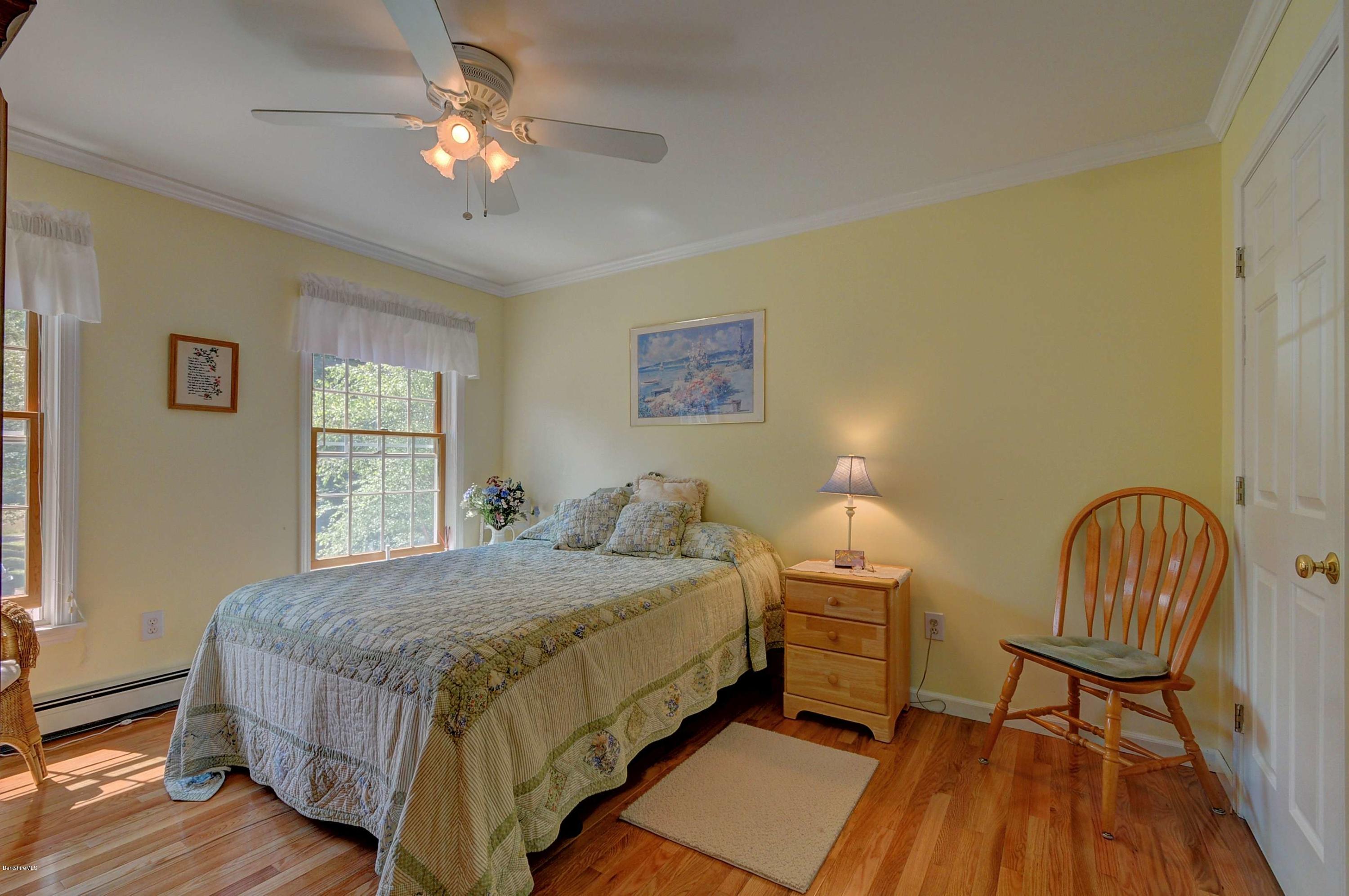 265 Smith Road Hinsdale, MA 01235 - Photo 25 of 27 a bedroom with a bed chairs and a window