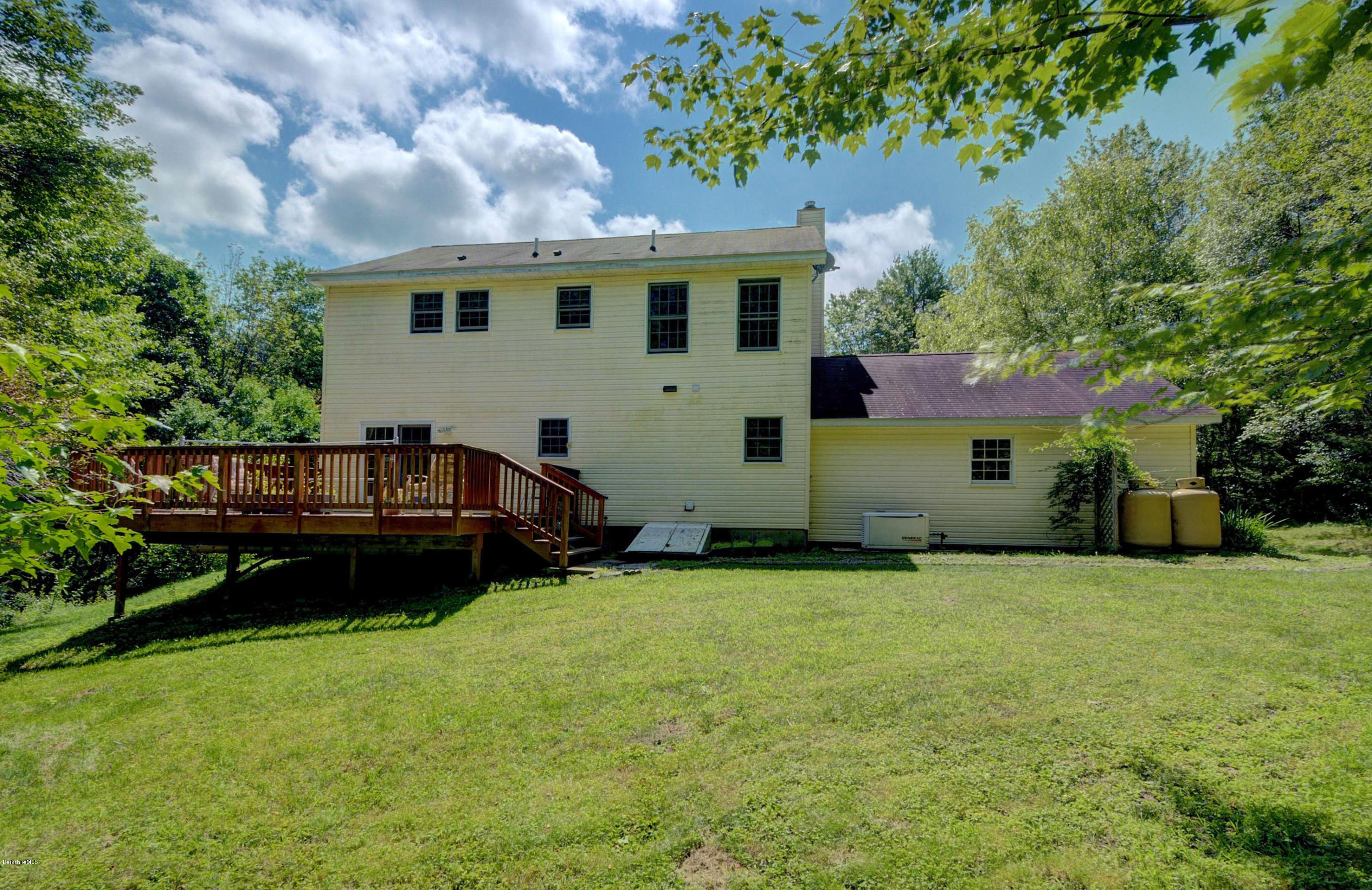 265 Smith Road Hinsdale, MA 01235 - Photo 6 of 27 a view of a house with a yard and a car park in front of house