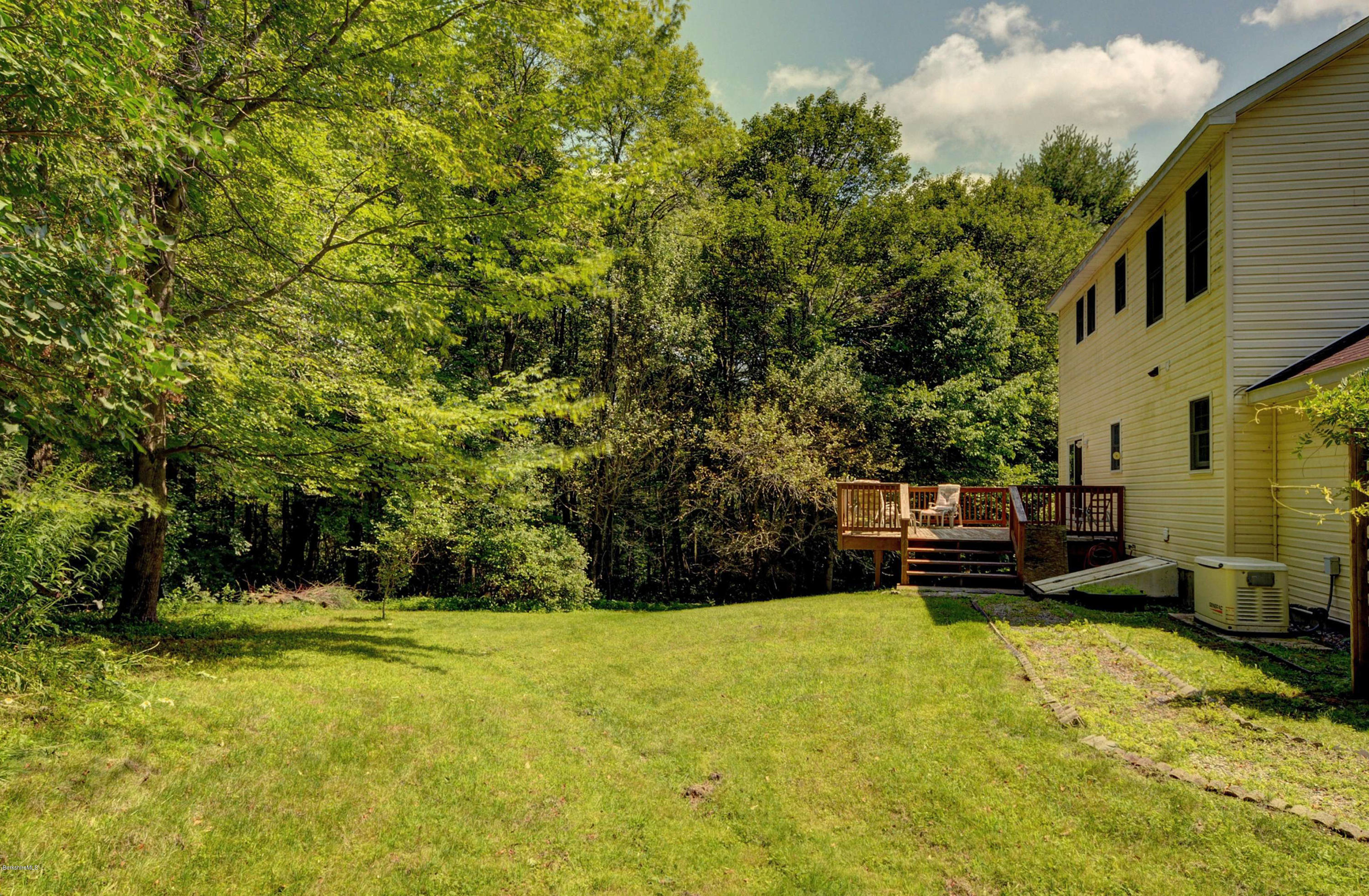 265 Smith Road Hinsdale, MA 01235 - Photo 7 of 27 a view of a swimming pool with lawn chairs under an umbrella