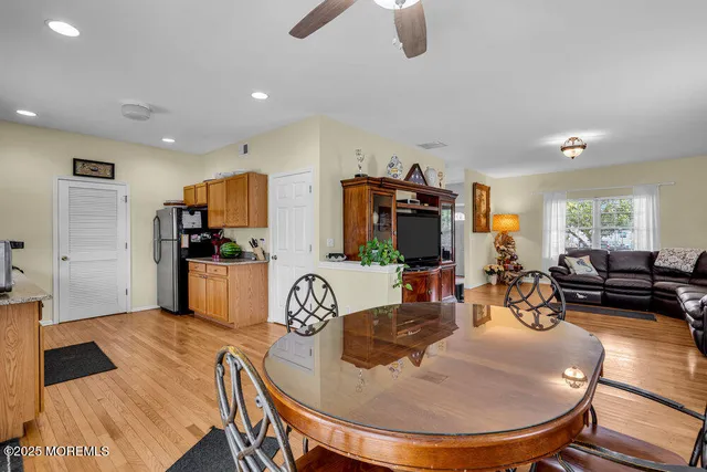 a kitchen with sink refrigerator dining table and chairs