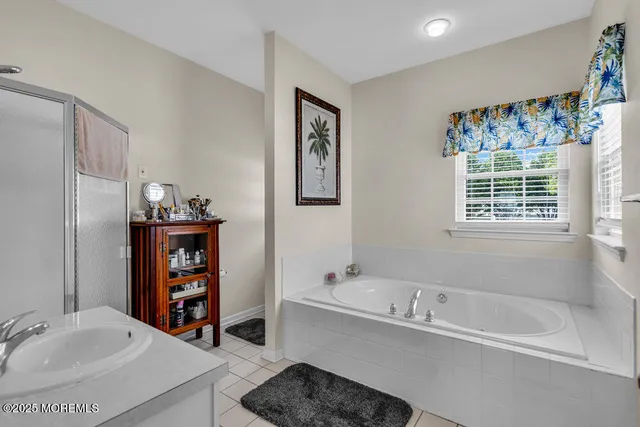 a bathroom with a bathtub sink and a shower