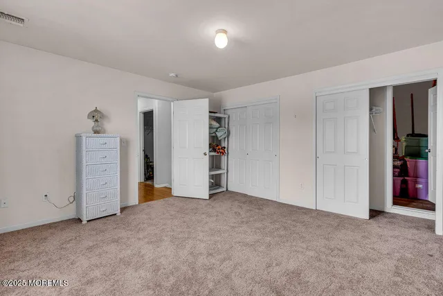 an empty room with closet and natural light