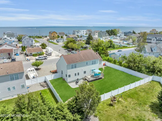 an aerial view of a house with yard swimming pool and outdoor seating