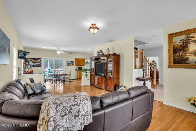 a living room with furniture and view of kitchen