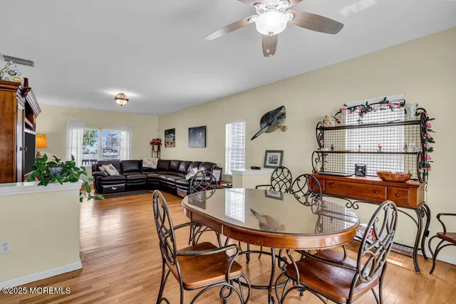 a dining room with furniture and wooden floor