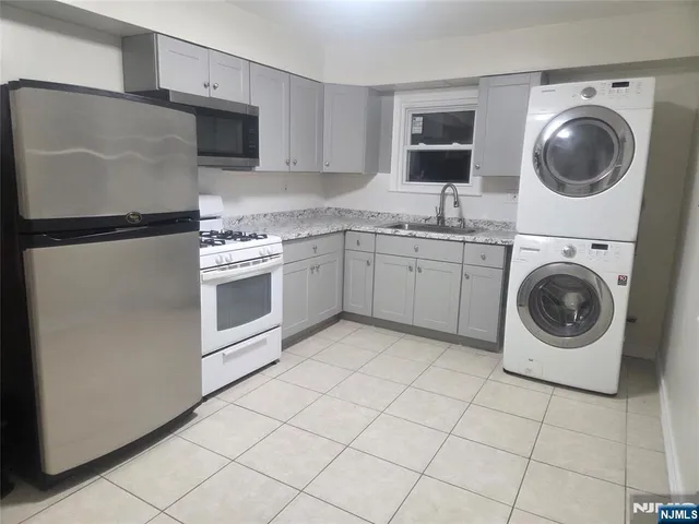 a kitchen with cabinets and stainless steel appliances