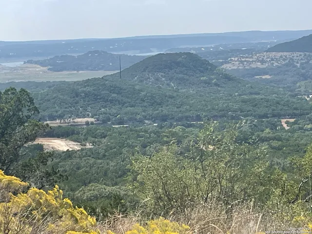 a view of a dry yard and mountain