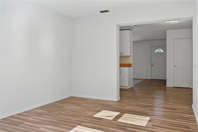 a view of a room with wooden floor and stairs