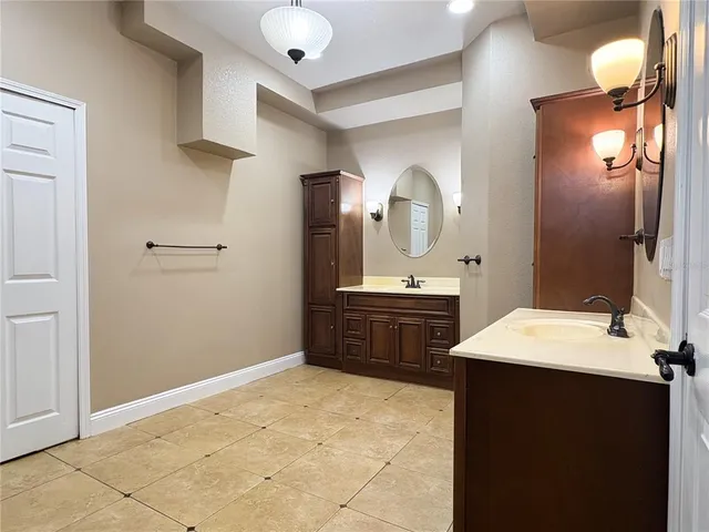 a spacious bathroom with a double vanity sink mirror and toilet
