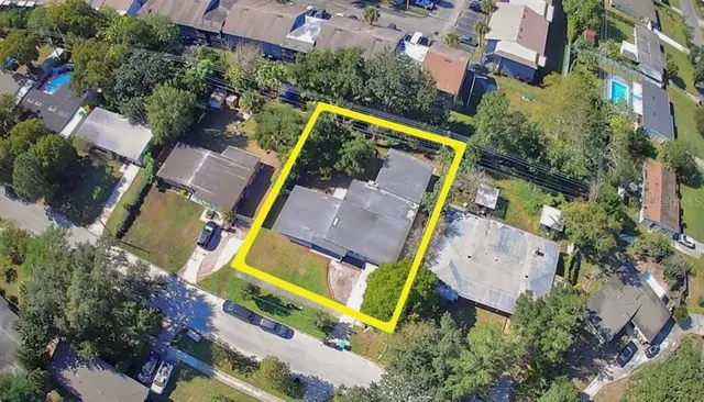 an aerial view of a house with yard