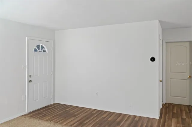 a view of a room with wooden floor and closet