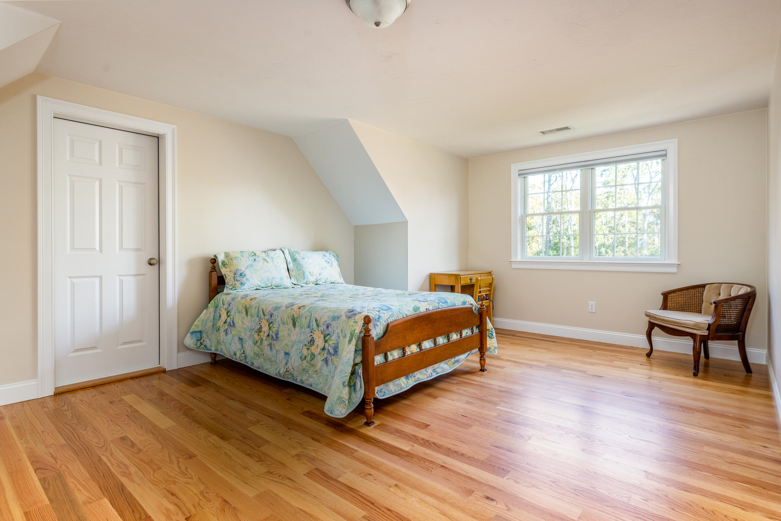 297 Depot Road Harwich, MA 02645 - Photo 16 of 22 a bedroom with a bed a chair and a window