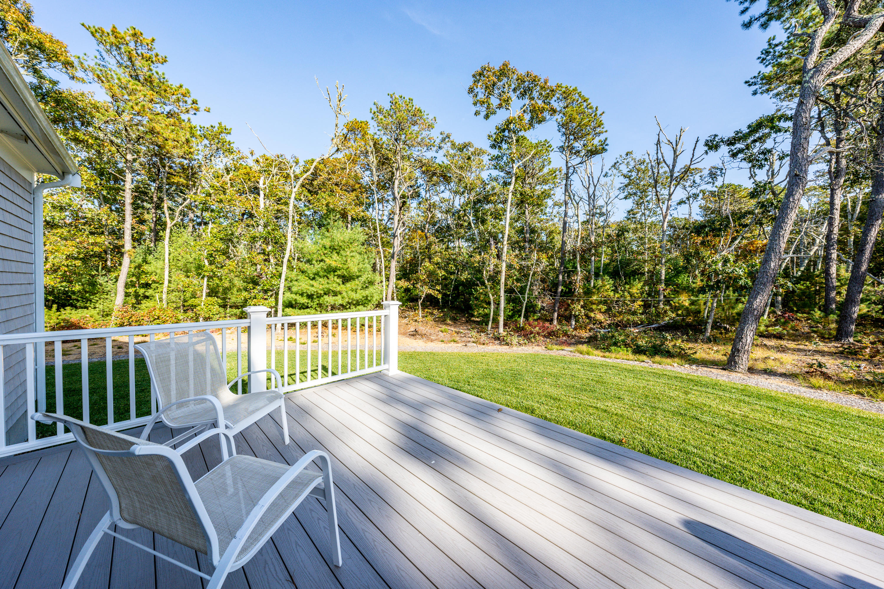 297 Depot Road Harwich, MA 02645 - Photo 19 of 22 a view of a chairs and table in patio with wooden fence