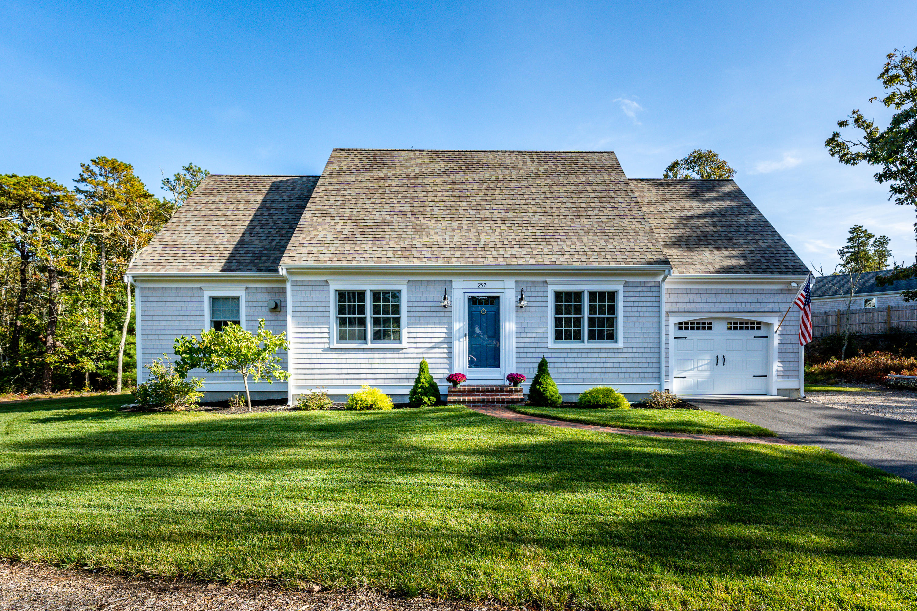 297 Depot Road Harwich, MA 02645 - Photo 20 of 22 a front view of house with outdoor seating yard and green space