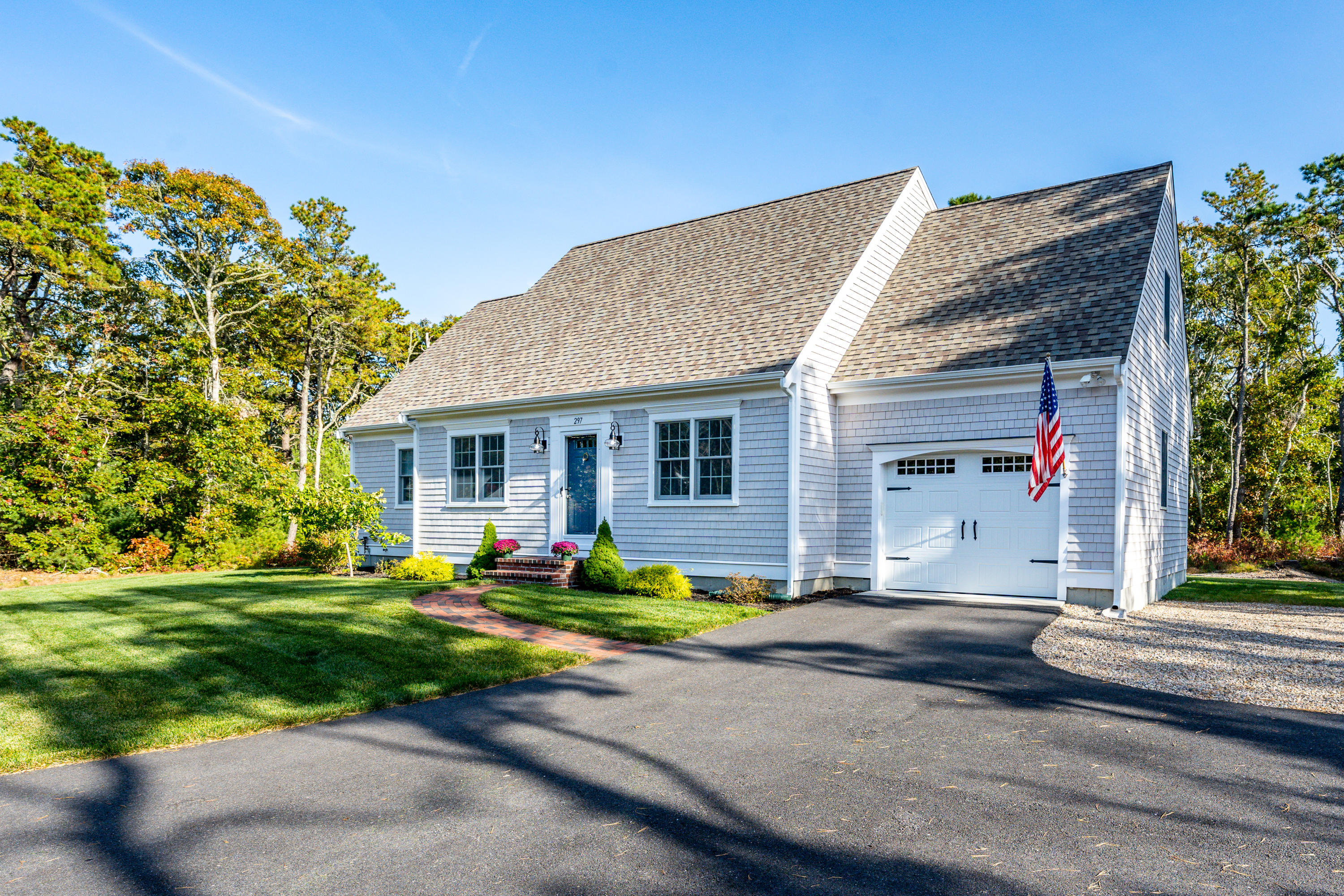 297 Depot Road Harwich, MA 02645 - Photo 21 of 22 a front view of a house with a yard and garage