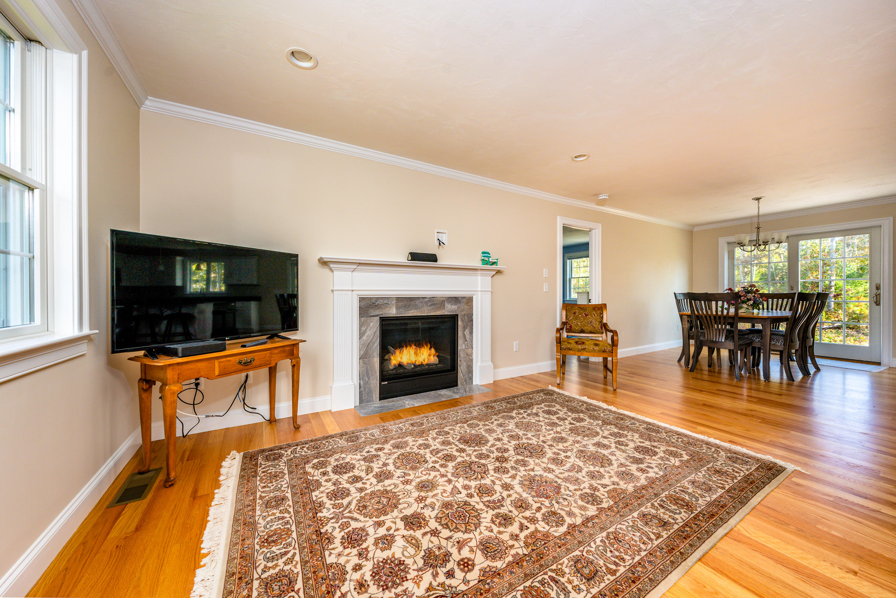 297 Depot Road Harwich, MA 02645 - Photo 4 of 22 a living room with furniture a flat screen tv and a fireplace