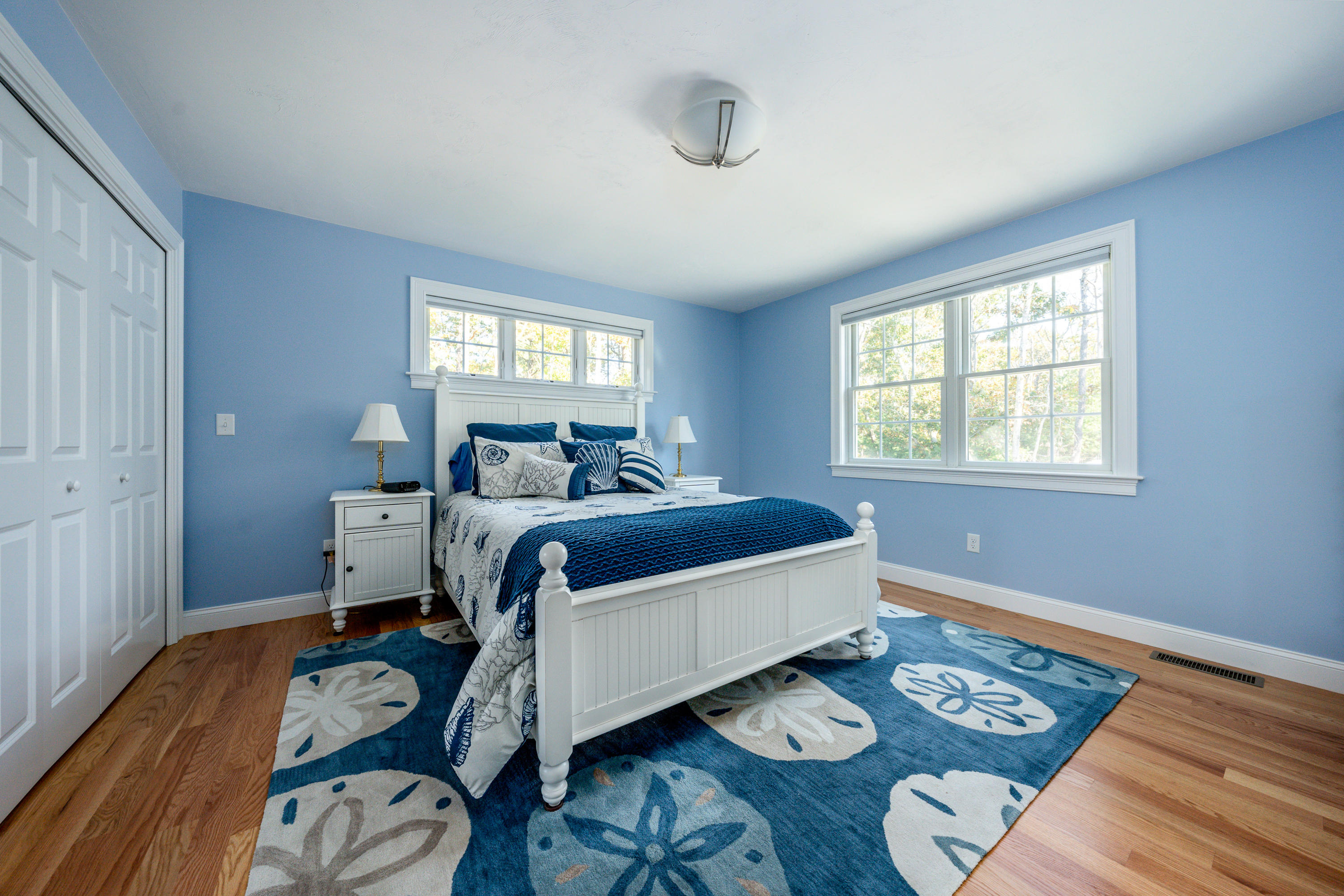 297 Depot Road Harwich, MA 02645 - Photo 10 of 22 a bedroom with a bed and wooden floor
