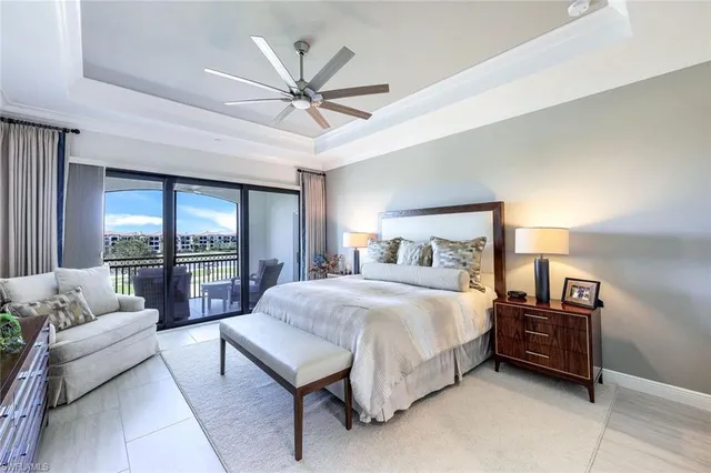 a bedroom with a bed a couch and a large window