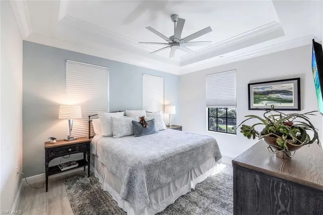 a bedroom with a bed and ceiling fan