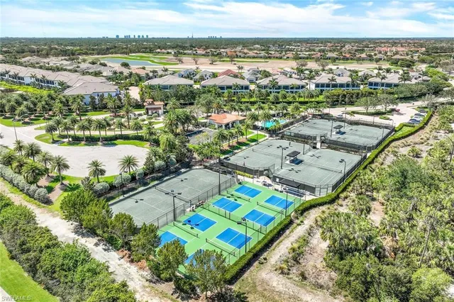 a view of a swimming pool with a lounge chair and palm trees