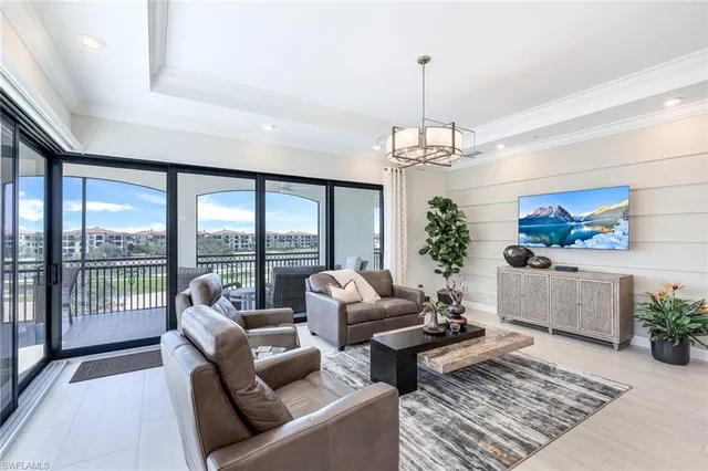 a living room with furniture and a chandelier