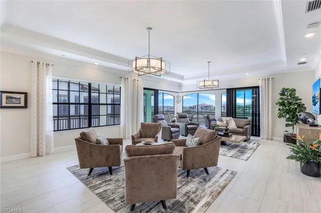 a living room with furniture potted plant and a chandelier