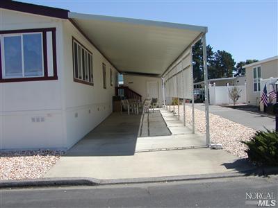 74 Middleton Drive, Unit 74 Santa Rosa, CA 95401 - Photo 1 of 1 Driveway, Patio area, and Shed behind the stairway entry to the back door.