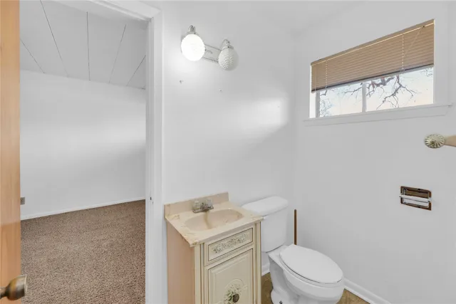 a white toilet sitting next to a bathroom sink