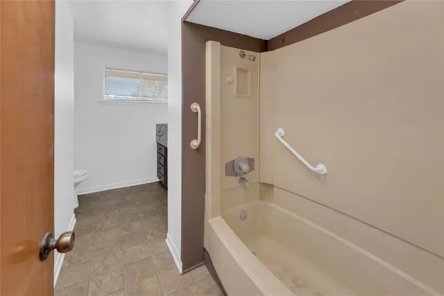 a bathroom with a bathtub and a shower