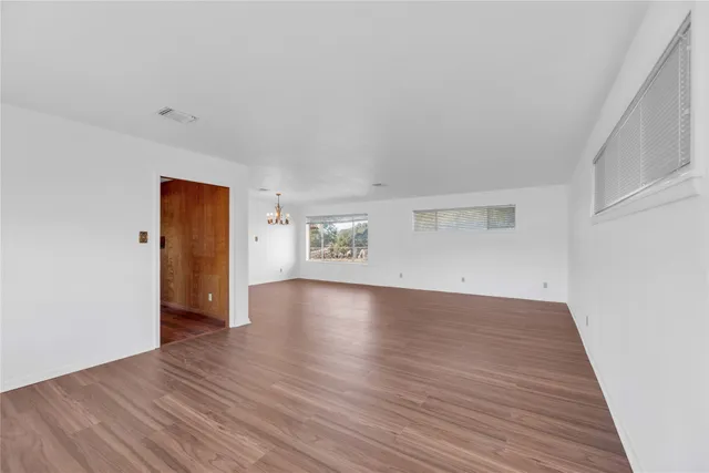an empty room with wooden floor and closet