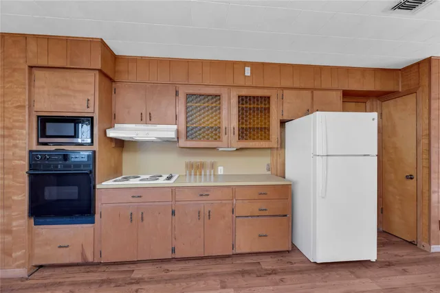 a kitchen with a refrigerator and a stove
