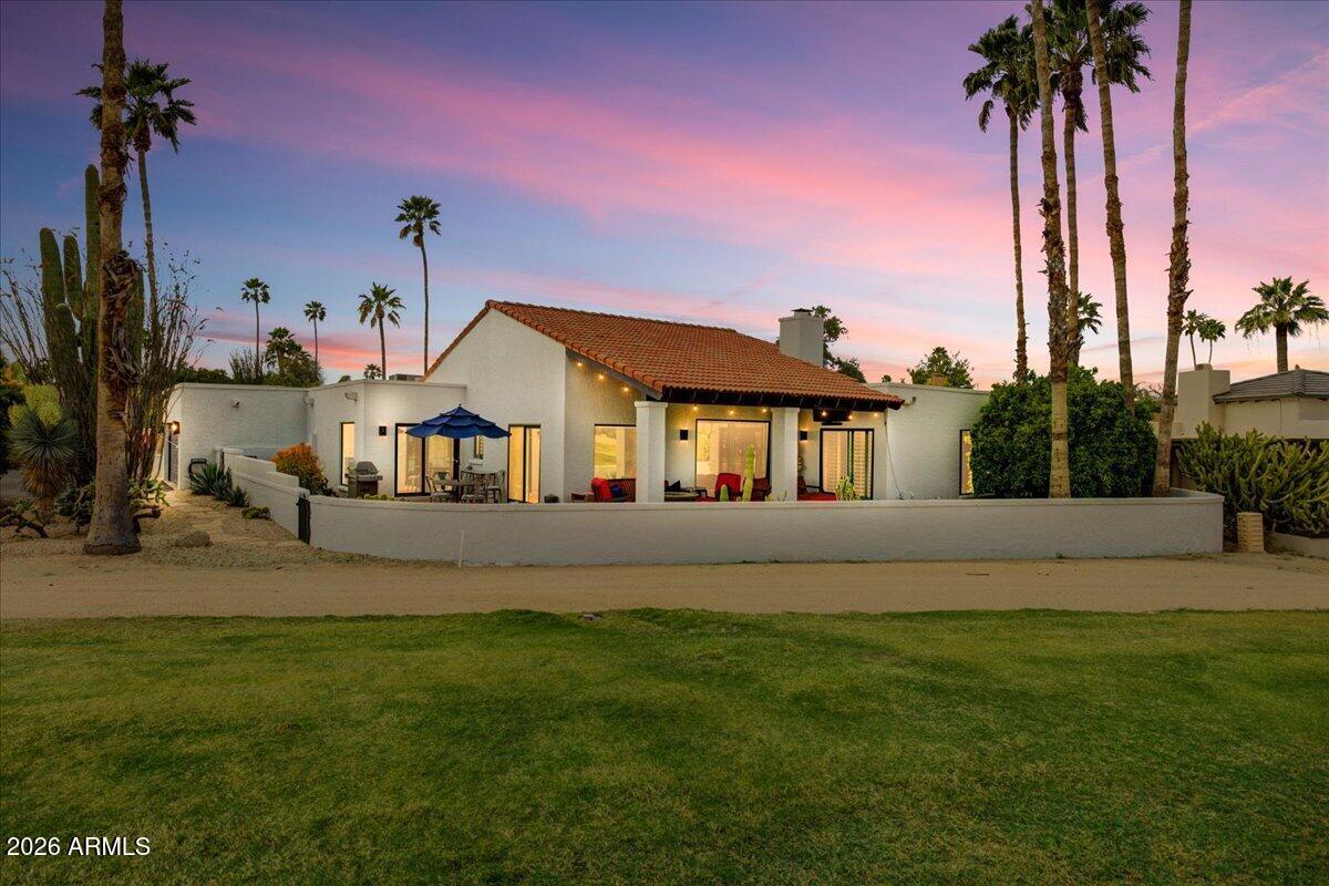 a front view of a house with a garden and yard